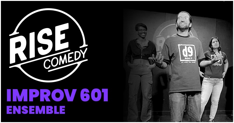 Black and white image of three performers on stage at Rise Comedy, part of the Improv 601 Ensemble. The foreground shows a man gesturing, while two other people stand in the background smiling.