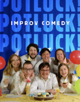 Seven people in white shirts smile and pose around a table with cupcakes, candles, and balloons. A blue backdrop reads POTLUCK! IMPROV COMEDY in bold letters. The mood is festive and cheerful.